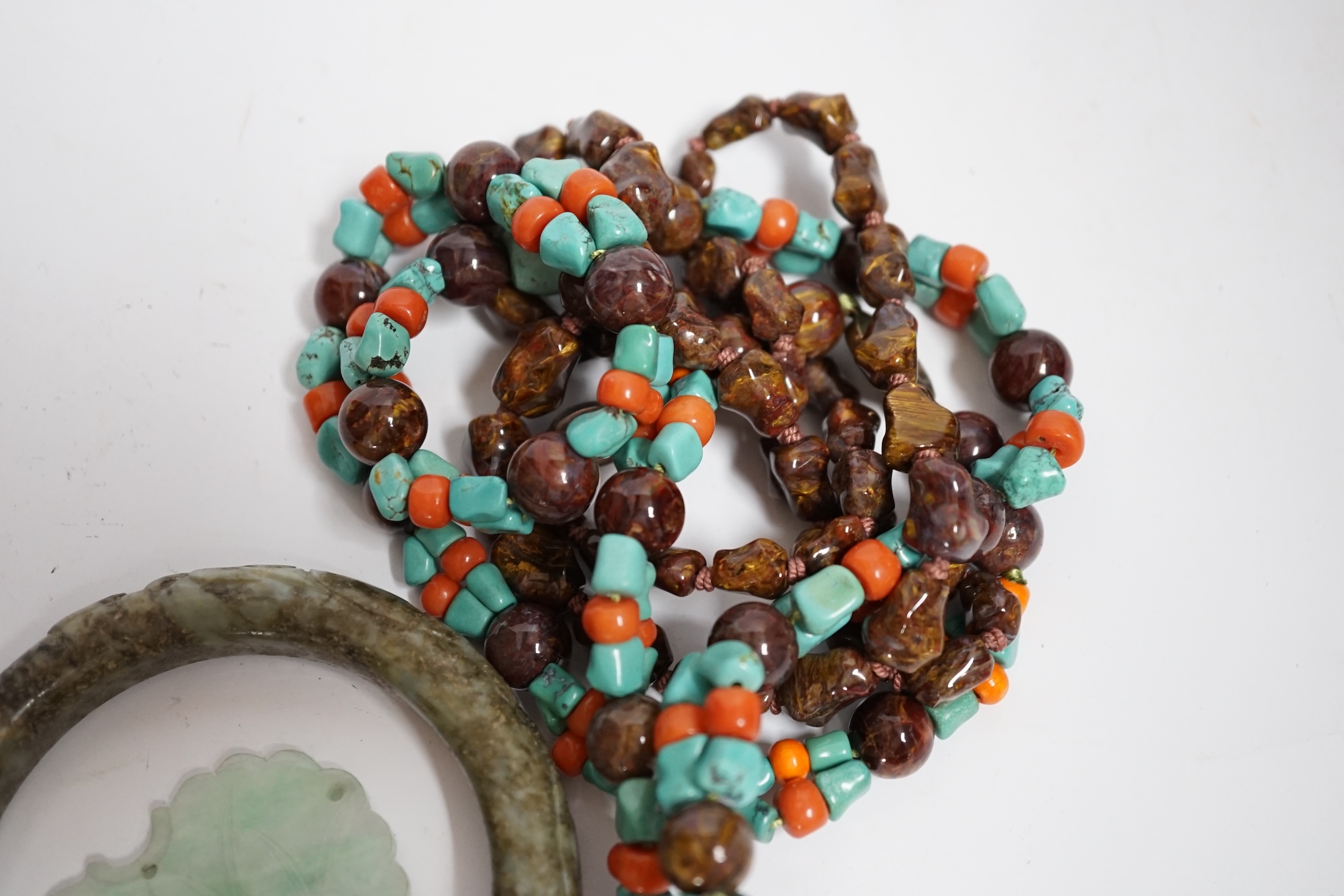 Two Chinese hardstone necklaces, a carved bangle and a jade carving, bangle 8.5cm in diameter